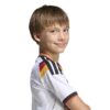 JZ4560_7_APPAREL_On Model_Detail View 2_white ADIDAS Maglia Home GERMANIA 26 Junior